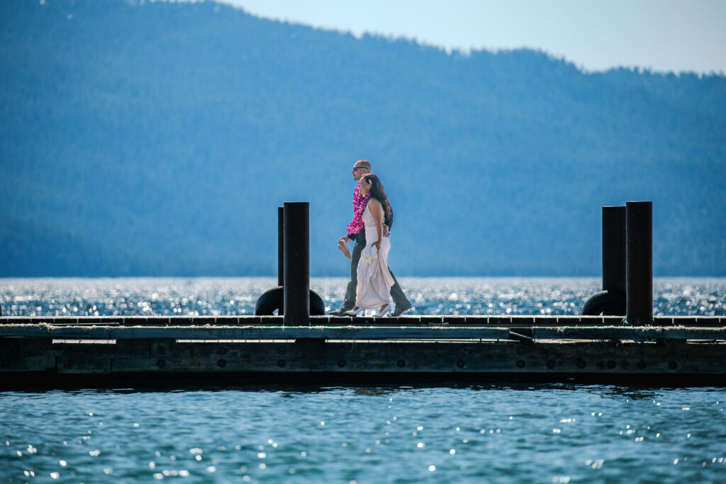 Round Hill Pines Resort Beach Wedding newlyweds walking along the pier