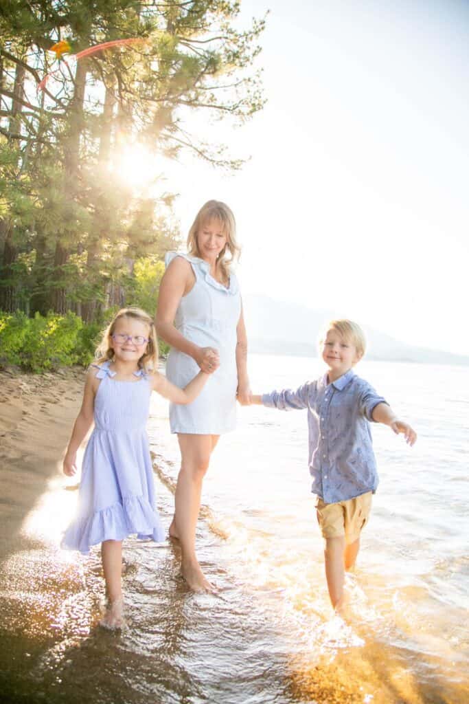 A mom with her two littles at Valhalla playing in the waves at Lake Tahoe 