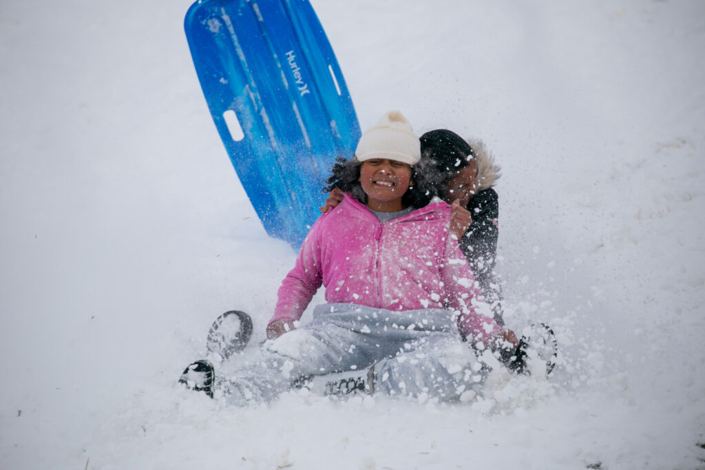 Big sis and Little sis, sled down the hill at the high school in Reno