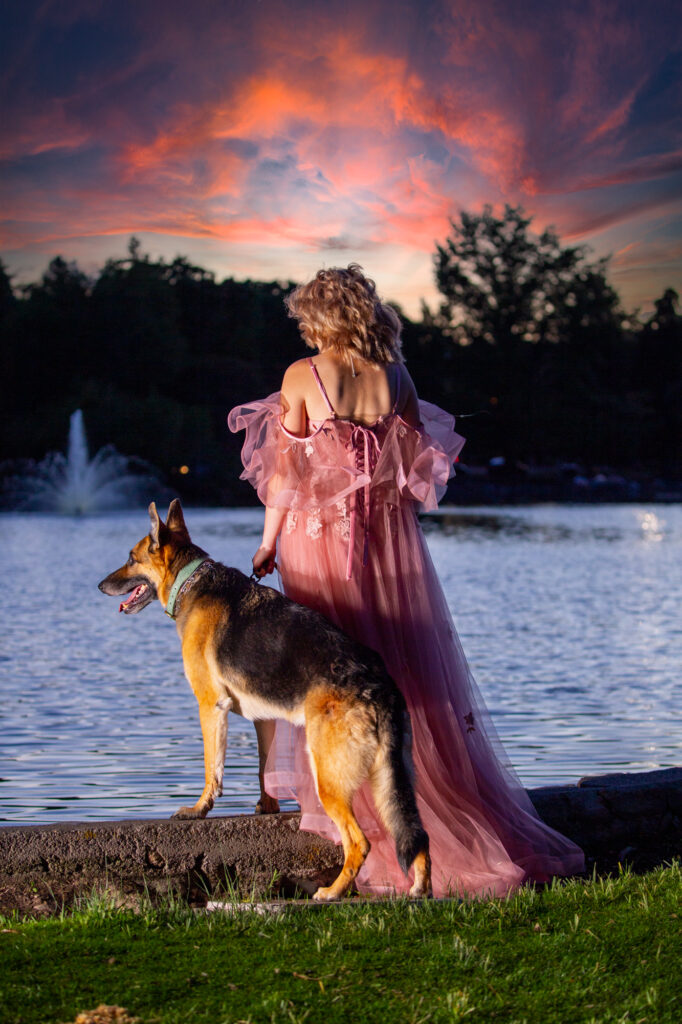 girl and her dog standing in front of fountain in Reno Park