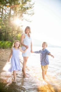 A mom with her two littles at Valhalla playing in the waves at Lake Tahoe