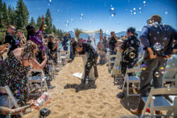 First Kiss surrounded by loved ones and bubbles