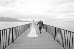 Couple of newlyweds walking the pier in Lake Tahoe keys marina